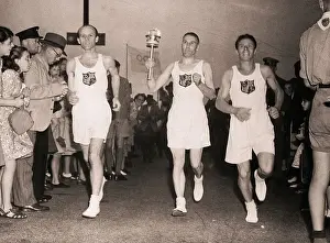 Runner Prints: Runners with Olympic Torch Run the Route