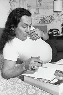 Russell Means On Phone, Pen In Hand