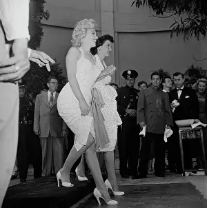 Prints of American actresses Marilyn Monroe (1926 - 1962, left) and Jane Russell (1921 - 2011) make imprints of their feet in wet cement in a joint handprint ceremony at Grauman's Chinese Theatre in Hollywood Hollywood's Sultry Siren – A Photographic Tribute: Russell, Monroe And Wet Cement