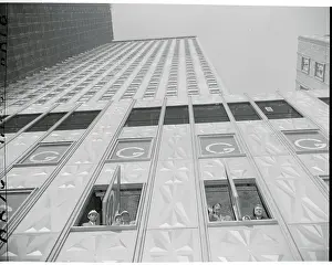 Overwhelming Prints: Russians in Windows of High Rise Building