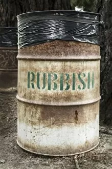 Rusty tin rubbish bin with word rubbish, New Zealand