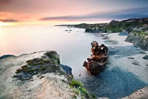 Rusty Wreck On the beautiful beach of Vila Nova de Milfontes in Portugal