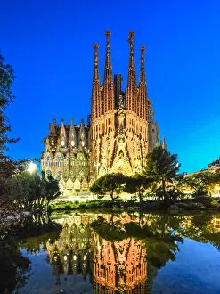Images Dated 24th August 2017: Sagrada Familia illuminated at dusk with reflection on lake in Barcelona, Catalonia