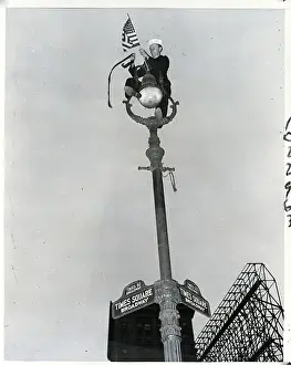 Street Sign Prints: Sailor On Light Post With Flag