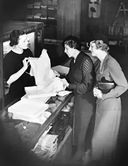 Presenting Prints: Sales clerk presenting lingerie to clients (B&W)