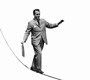 Tightrope Prints: Salesman with briefcase walking tightrope