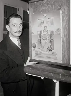 Salvador Dali Holding Framed Painting