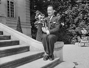 Salvador Dali Holds Dog By Neck