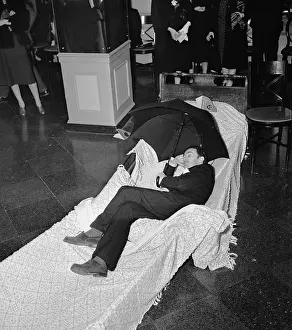 Salvador Dali Lying Down and Holding Umbrella