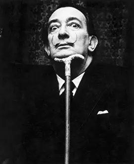 Salvador Dali Resting His Head on Cane