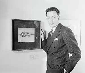 Salvador Dali Standing by Framed Picture