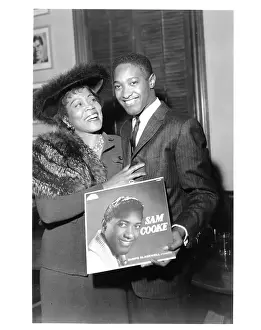 Prints of LOS ANGELES - CIRCA 1958: Soul singer Sam Cooke holds up his eponymous debut album as he poses for a photo with Gertrude Sugar Hall circa 1958 in Los Angeles, California The man known as the King of Soul: Sam Cooke And Gertrude Hall