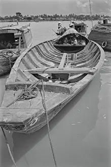 Prints of Children shelter in a covered section of a sampan moored on a stretch of the Saigon River as it flows through Saigon, Vietnam, 30th August 1965 Vietnam Prints: Sampan On The Saigon River