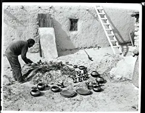 Artisanship Prints: San Ildefonso Indian Examining Pottery