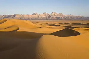 Sand Dunes Prints: Sand dunes in front of the Idinen Mountains in the Libyan Desert