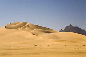 Sand Dunes Prints: Sand dunes in front of the Idinen Mountains in the Libyan Desert