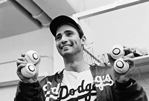 Sandy Koufax Holding 4 Zero Baseballs