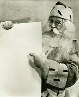 One Senior Man Only Prints: Santa Claus holding blank sheet of paper, (B&W), portrait