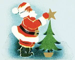 Santa puts the star on the tree