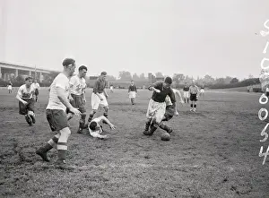Prints of (Original Caption). Bill Fagan (9), of Liverpool Reds, affects a little nimble footwork as he blankets view of opponent J. O'Connell, of American League All-Stars. Not so nimble is All-Stars J Kicking Through History:Iconic Soccer Moments: Scene During Liverpool Reds-American Soccer League All-Star Contest