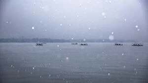 Images Dated 5th December 2015: Scenic View Of Silhouette Boats On the West Lake In Snow, Hangzhou
