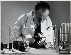 Test Tube Prints: Scientist Peers into Microscope