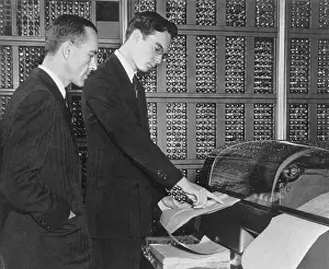 Calculator Prints: Scientists Reading Results from Selective Sequence Electronic Calculator