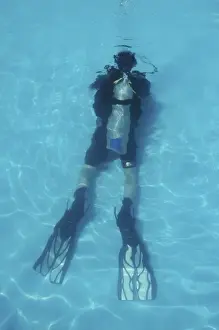 Diver Prints: Scuba diver, young man, in swimming underwater in swimming pool, high angle view