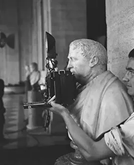 Sculpture Holding a Camera