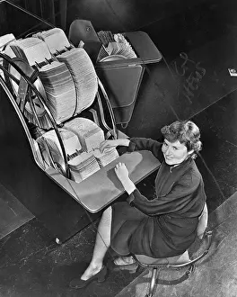 Searching Prints: Secretary Flips Through Ferris Wheel File