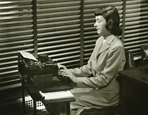 Wavy Hair Prints: Secretary typing on typewriter in office, (B&W)