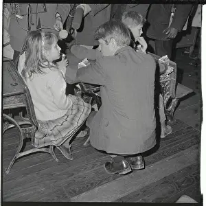 Senator Robert Kennedy Stooping to Talk with Young Girl