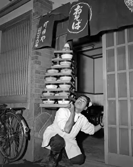 Senichi Okashita Going Through Doorway with Noodle Bowls
