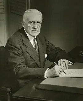 Pince Nez Prints: Senior businessman signing documents at desk, (B&W), portrait