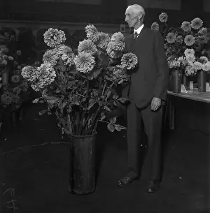 Vase Prints: Senior man looking at flowers