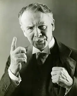 Mustache Prints: Senior man in full suit scolding, (B&W), portrait