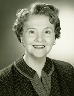 Senior Women Prints: Senior woman smiling in studio, (B&W), close-up, portrait
