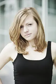 Femininity Prints: Sensual portrait of a young long-haired woman in a black tank top