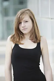Femininity Prints: Sensual portrait of a young long-haired woman in a black tank top