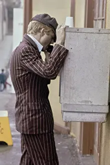 Prints of American actor Robert Redford wearing a striped brown jacket and a grey newsboy cap, using a payphone on the set of The Sting, filmed in the United States, 1973 Robert Redford: Classic Hollywood Elegance: On The Set Of The Sting
