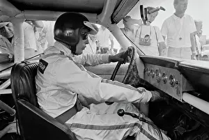 Prints of American actor Paul Newman, wearing racing coveralls, a crash helmet and sunglasses, sits at the wheel of his car on the set of Winning Paul Newman: A Life in Frames: On The Set Of Winning