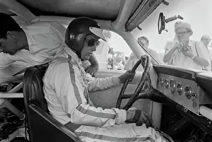 Prints of American actor Paul Newman, wearing racing coveralls, a crash helmet and sunglasses, sits at the wheel of his car on the set of Winning Paul Newman: A Life in Frames: On The Set Of Winning