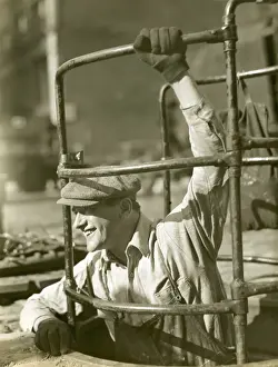 Sewer worker descending below street
