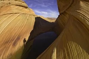 Shadow of man photographing scenic sandstone