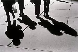 Small Group Of People Gallery: Shadows of people walking on sidewalk