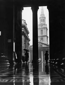 Prints of February 1928: People sheltering from the rain under the portico of the National Gallery in London. The church of St-Martin-in-the-Fields can be seen in the background Timeless Treasures: Iconic Black and White Prints from the Fox Photo Library: Sheltering From Rain