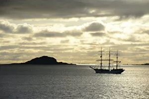Images Dated 6th August 2012: Ship sailing past an island at sunset, Insel Havsteinen, Alesund, More og Romsdal, Western Norway