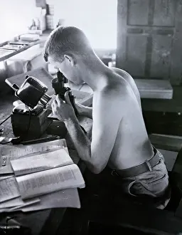 Disease Prints: Shirtless Man Looking Into Microscope