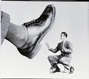 Giant Prints: Shoe Salesman Faced with Giant Shoe