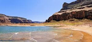 Shore of Lake Powell, surrounded by red Navajo sandstone cliffs, rock formations, Page, Arizona, USA